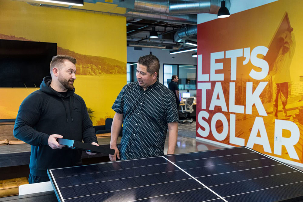 an oc solar team member having a consultation with a homeowner
