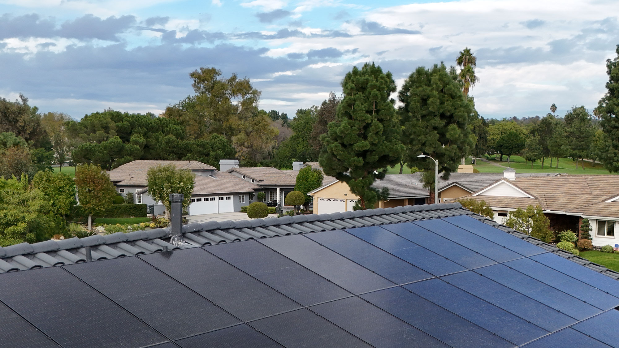a close-up of solar panels installed on an orange county roof